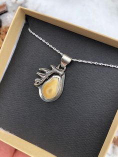 A beautiful way to treasure a hunt! This sterling silver pendant features an Elk Ivory and antler designs on an adjustable sterling chain. Made to order: please allow 6-8 weeks for delivery. After order is placed I will contact you via email to begin the custom order process. You may choose your stone and I can send images of the layout for your approval. Each pendant is unique and handcrafted around the stone and/or Elk Ivories. If you would like a different stone (other than turquoise) please Nature-inspired Sterling Silver Teardrop Pendant Jewelry, Untreated Nature-inspired Pendant Jewelry, Nature-inspired Sterling Silver Jewelry With Polished Finish, Nature-inspired Amber Sterling Silver Jewelry, Untreated Amber Jewelry Gift, Untreated Sterling Silver Necklaces As Gifts, Untreated White Gold Jewelry Gift, Elk Ivory Jewelry, Ivory Jewelry