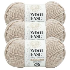 three skeins of wool - ease yarn in beige, white and brown colors