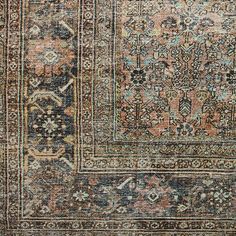 an antique rug with many different colors and patterns