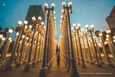 a person standing in front of many street lights