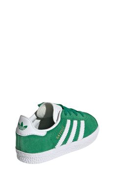 Initially designed in '91 as a training shoe for top athletes, the iconic Gazelle sneaker has been refreshed with stretchy laces for your little athlete. Pull-on style with elastic laces Leather and synthetic upper/textile lining/rubber sole Imported Green Adidas Sneakers With Laces, Green Adidas High-top Lace-up Sneakers, Green Lace-up High-top Sneakers With Adidas Logo, Green Lace-up High-top Sneakers For Jogging, Green Adidas Sneakers With Three Stripes, Green Sneakers With Laces For Jogging, Green Skate Shoes For Sports With Laces, Adidas Jogging Sneakers With Rubber Sole, Adidas Sneakers With Rubber Sole For Jogging