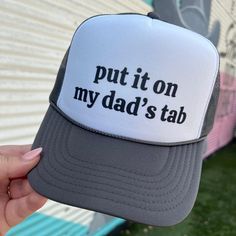 Get your hands on the On My Dad's Tab Trucker hat, the perfect accessory for any occasion. With its bold and witty slogan, "Put it on my dad's tab," this hat is sure to make a statement. Show off your sense of humor and relaxed style while also enjoying the practical benefits of sun protection. A must-have for any hat collection. Snap back Trucker Otto Snackback color: black Ships in 10 business days or sooner Funny Letter Print Hats For Gift, Funny Letter Print Hats As Gifts, Funny Letter Print Hat As Gift, Adjustable Fashion Baseball Cap With Letter Print, Funny Hats With Letter Print As Gift, Father's Day Letter Print Snapback Hat, Novelty Letter Print Adjustable Baseball Cap, Novelty Flat Bill Hat With Letter Print, Novelty Snapback Hat With Letter Print And Curved Brim