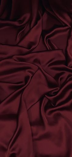 an image of a bed with red sheets