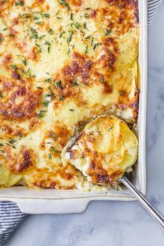 a casserole dish with cheese and herbs in it, ready to be eaten