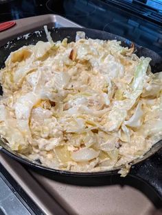 a pan filled with food sitting on top of a stove