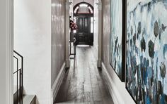 a long hallway with paintings on the walls