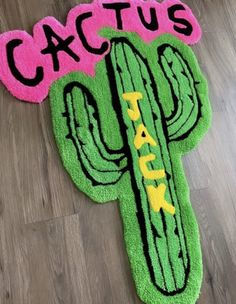 a cactus rug that says cactus park on the front and back of it, sitting on top of a wooden floor