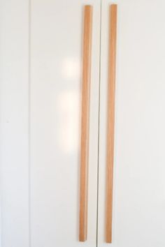 two wooden sticks sticking out of the wall