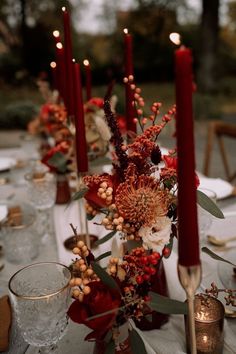 the table is set with candles and flowers