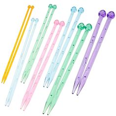 six different colored plastic pens and two pairs of ear buds