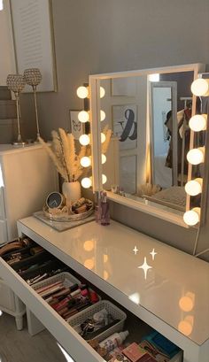 a white vanity with lights on it