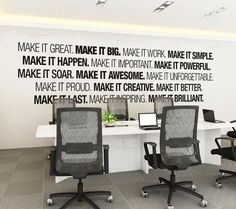 two office chairs sitting in front of a wall with words on it