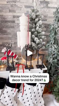 a christmas stocking display with candles, stockings and other decorations on top of it