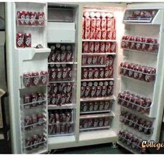 an open refrigerator filled with lots of red and white soda cans in it's doors