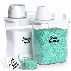 a blender filled with lots of green beads next to a measuring cup full of candy