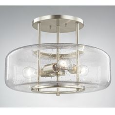 a semi flush ceiling light with clear glass shades