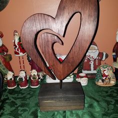 a heart shaped wooden sculpture sitting on top of a table