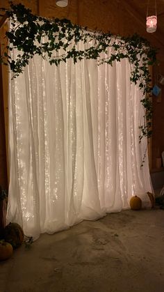 a white curtain with green vines hanging from it