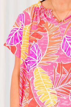 Look stylish and confident in our Make Peace Top, featuring a vibrant tropical pattern and bold colors that are perfect for the season! The ruffle detailing adds a feminine touch! Stay on trend with this must-have piece! 100% Polyester Patterned Ruffle Tops For Vacation, Patterned Ruffled Tops For Vacation, Spring Beachwear Top With Vibrant Print, Pink Palm Tree Print Top For Beach, Pink Palm Tree Print Beach Top, Chic Vibrant Print Beach Top, Chic Beach Tops With Vibrant Print, Vacation Tops With Bold Print, Chic Beach Top With Vibrant Print