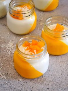 small jars filled with orange and white desserts