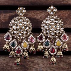 Add a splash of color and elegance to your look with these stunning Multi Dharna Designer Earrings. Featuring a beautiful array of multi-colored stones set in an intricate traditional design, these earrings are perfect for special occasions or as a bold statement piece. Handmade with attention to detail, these earrings will make you stand out at any event. Features: *Vibrant Multi-Colored Stones: A mix of ruby, emerald, yellow, and other gemstone hues,                  complemented by delicate p Luxury Multicolor Earrings For Diwali, Traditional Indian Jewellery, Ruby Emerald, Colored Stones, Designer Earrings, Traditional Design, Statement Jewelry, Indian Jewelry, Multi Colored