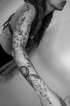 a woman with tattoos on her arms and arm