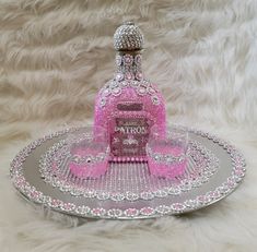 a pink and silver tray with a bottle on it that says parrox in the center