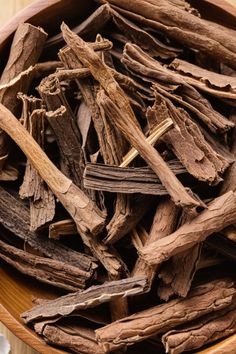 a wooden bowl filled with cloves on top of a table