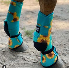 the legs and feet of a person wearing sunflower boots