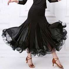 a woman in a black dress is dancing