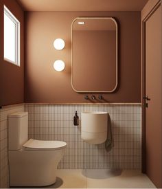 a white toilet sitting next to a bathroom sink under a mirror on a brown wall