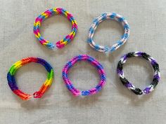 four different colored bracelets sitting next to each other