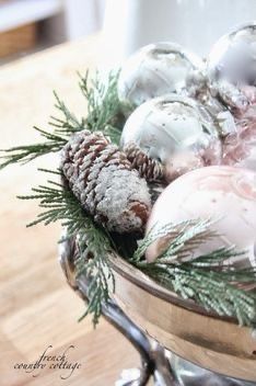 a bowl filled with ornaments on top of a wooden table