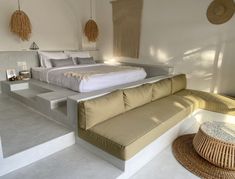 a large bed sitting on top of a white floor