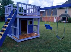 there is a small blue house with a swing set in the yard and stairs leading up to it