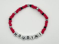 Show your love for Dua Lipa with this beaded bracelet in a red, black and silver colour scheme and spelling out the name of her latest single Houdini. Bracelets are 17cm long and made with stretchy elastic cord. All bracelets are made to order and will be dispatched within 3 days by Royal Mail Second Class. Personalized Red Name Bracelet With Round Beads, Red Custom Name Bracelet For Friendship, Customized Red Beaded Bracelets With Round Beads, Red Beaded Name Bracelet With Round Beads, Red Beaded Name Bracelet, Personalized Red Wristband With Round Beads, Adjustable Red Name Bracelet With Round Beads, Dua Lipa Concert, Silver Color Scheme