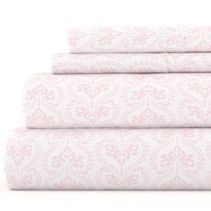 four sheets with pink and white designs on them