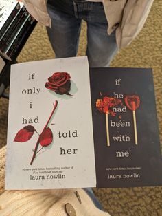 two books sitting next to each other on top of a carpeted floor in front of a person