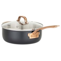 a black and gold pan with wooden handles