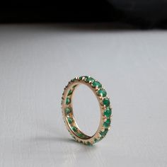 Gorgeous Emerald Eternity ring in your choice of Karat and Gold Color. Featuring between 2.35-2.52ctw (Subject to size). Natural Grade AAA Emeralds with that wonderful sought after green and Very Good clarity. Each ring is made to Order and set with meticulously handpicked Emeralds to ensure the most elegant results. All questions and custom requests welcome!, Fast turn around. ----------------------DIMENSIONS---------------------- This rings shank is 3.4 mm to accommodate the 3 mm Emeralds. The Classic Green Round Eternity Band, Classic Green Eternity Band, Green Eternity Band With Vvs Clarity In Round Shape, Round Emerald Eternity Band With Prong Setting, Emerald Gold Ring, Emerald Eternity Ring, Light Teal, Multi Stone Ring, Eternity Ring