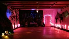 the dance floor is lit up with pink lights and decorations for halloween party guests to sit on