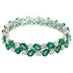 Sophia D platinum bracelet with 35 round diamonds that totals 12.83 carats and 34 pear cut emeralds that totals 22.26 carats. The length is 18 cm and is about 1 cm wide. Sophia D by Joseph Dardashti LTD has been known worldwide for 35 years and are inspired by classic Art Deco design that merges with modern manufacturing techniques. Gold Jewelry Simple Necklace Unique, Diamond Bracelet Design Unique, Expensive Bracelets, Emerald Bracelets, Modern Diamond Rings, Jewelry Rings Unique, Diamond Bracelet Design, Platinum Bracelet, Diamond Rings Design