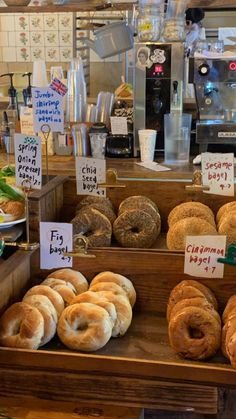 various types of doughnuts on display in a bakery