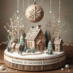 an ornament with a house and snowflakes hanging from it