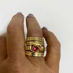 "This captivating, multiband, gold-filled ring features a stunning pink ruby and a beautiful Hebrew engraving of the Jewish Psalm Woman of Valor (Eshet Chayil.) With the ruby representing passion and the psalm a romantic verse from Husband to wife on Sabbath eve, this piece makes for a meaningful anniversary gift, engagement, or promise ring. The psalm is also fittingly an acrostic - every first letter in verse creates the entire Hebrew alphabet from the letter 'Aleph' to 'Tav', representing a c Gold Stackable Rings With Pink Sapphire, Gold Pink Sapphire Round Ring, Gold Ruby Ring Stamped 14k, Gold Stackable Ruby Ring, Heirloom Gold Ruby Ring Engraved, Heirloom Gold Engraved Ruby Ring, Gold Stackable Ruby Birthstone Ring, Gold Rings With Pink Sapphire In Fine Jewelry Style, Gold Ruby Rings With 17 Jewels