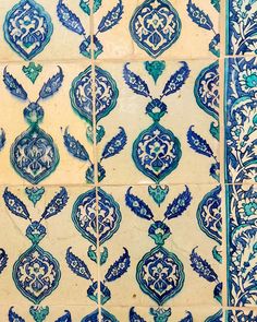 blue and white tiles with designs on them