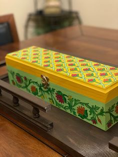 a decorative box sitting on top of a wooden table