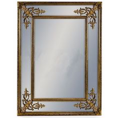 an ornate gold framed mirror on a white wall