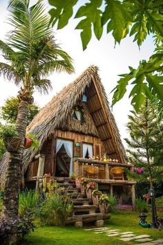 a small house with a thatched roof and steps leading up to it