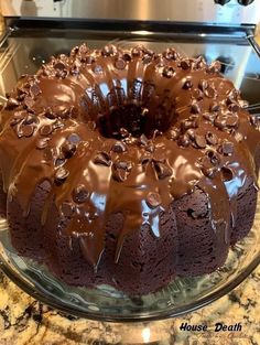 a chocolate bundt cake on a glass platter